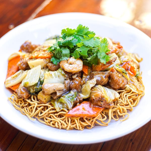 Crispy Vietnamese egg noodles topped with stir-fried beef, shrimp, and mixed vegetables.