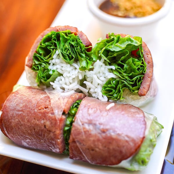 Basil & Mint's Vietnamese spring rolls with sausage, lettuce, and rice noodles, served with dipping sauce.